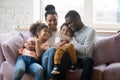 Happy biracial family with kids relax on cozy sofa Royalty Free Stock Photo