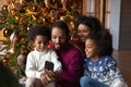 Happy biracial family with kids use cellphone together Royalty Free Stock Photo