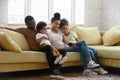 Happy biracial family with kids using cellphone together Royalty Free Stock Photo