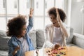 Happy biracial mom and daughter engaged in creative activity