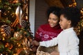 Happy biracial mother and son prepare for New Year Royalty Free Stock Photo