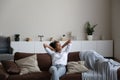 Happy biracial woman rest on sofa in cozy home Royalty Free Stock Photo