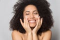 Happy biracial young woman preform skincare routine Royalty Free Stock Photo