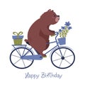 Happy birthay card with a bear on a bike carrying a present and flowers.