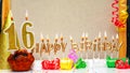 Happy birthday background with golden candles and decorations with candles burning number 16. Colorful festive card happy Royalty Free Stock Photo