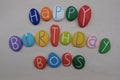 Happy Birthday Boss with colored stones over white sand Royalty Free Stock Photo