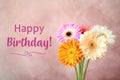 Happy Birthday! Bouquet of beautiful bright gerbera flowers on pink background