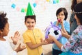 Happy birthday boy receives football ball as birthday gift. Happy birthday party. Royalty Free Stock Photo