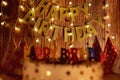 Happy birthday cake on the background of garlands and letters Royalty Free Stock Photo