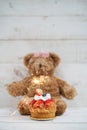 Happy Birthday. Birthday cake with blurred teddy bear on the white wooden background. Soft focus on strawberry. Royalty Free Stock Photo