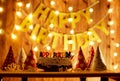 Happy birthday cake with candles on the background of garlands a Royalty Free Stock Photo