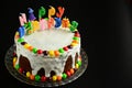 Happy birthday cake with candles on black background Royalty Free Stock Photo