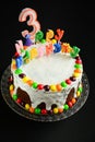 Happy birthday cake with candles on black background Royalty Free Stock Photo