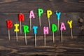 happy birthday cake candles on wooden background Royalty Free Stock Photo