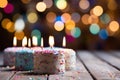 Happy birthday cake with colorful candles and festive confetti background celebration Royalty Free Stock Photo