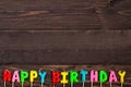happy birthday candle letters on dark wooden Royalty Free Stock Photo