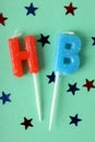 Happy birthday candles and glitter on mint background Royalty Free Stock Photo