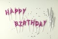 Happy birthday candles and glitter on white background Royalty Free Stock Photo