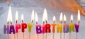 Happy Birthday candles lighted. Royalty Free Stock Photo