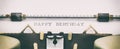 HAPPY BIRTHDAY in capital letters on a typewriter sheet