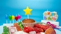 Happy birthday card, festive cupcake with birthday decorations on blue background Royalty Free Stock Photo