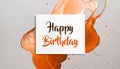 Happy birthday card note on muted orange design background,