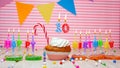 Happy birthday card to a child of ten years old on a pink background, with a number in a cupcake. Beautiful happy birthday Royalty Free Stock Photo