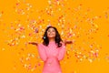 Happy birthday! cheerful funny ethnic woman with festive confetti on yellow