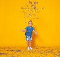 Happy birthday child boy with confetti on yellow background Royalty Free Stock Photo