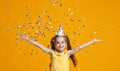 Happy birthday child girl with confetti on yellow background Royalty Free Stock Photo