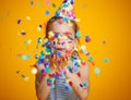 Happy birthday child girl with confetti on yellow background Royalty Free Stock Photo