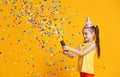 Happy birthday child girl with confetti on yellow background Royalty Free Stock Photo