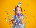 Happy birthday child girl with confetti on yellow background Royalty Free Stock Photo