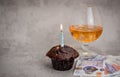 Happy birthday Chocolate maffin on gray background with candle and glass cognac and English money