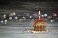 Happy birthday cupcake and bow candle on table on wooden background with copy space. Cute food happy birthday background concept Royalty Free Stock Photo