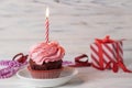 Happy birthday cupcake with pink cherry flavor frosting with lit candle Royalty Free Stock Photo