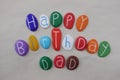 Happy Birthday Dad with colored stones over white sand Royalty Free Stock Photo