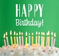 Happy Birthday! Delicious cake with burning candles on green background Royalty Free Stock Photo