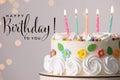 Happy Birthday! Delicious cake with party decor on stand against light grey background, closeup Royalty Free Stock Photo