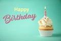 Happy Birthday! Delicious cupcake with candle on light green background