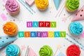 Happy Birthday. Flat lay composition with colorful cupcakes on white background Royalty Free Stock Photo