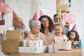 Happy birthday, gift and big family celebrate with cake in a home party, event and candles in a house together. Mother Royalty Free Stock Photo