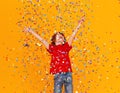 Happy birthday! ginger child boy with confetti on yellow background Royalty Free Stock Photo