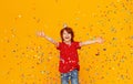 Happy birthday! ginger child boy with confetti on yellow background Royalty Free Stock Photo