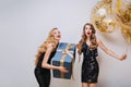 Happy birthday great party time of two charming funny young women on white background. Black luxury dresses, elegant