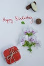 Happy birthday greeting card with gift box, fresh flowers and chocolates