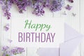 Happy birthday greeting card with lilacs. Spring card with branches of lilac on an all-round wooden background with a postal Royalty Free Stock Photo