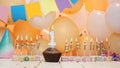 Happy birthday greetings for a child of 1 year old from golden letters of candles burning against the background of balloons copy Royalty Free Stock Photo