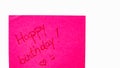 Happy birthday handwriting text close up isolated on pink paper with copy space. Writing text on memo post reminder Royalty Free Stock Photo