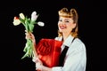 Happy birthday. Happy woman with present and flower. Girl with tulips and red surprise box on black background. Womens